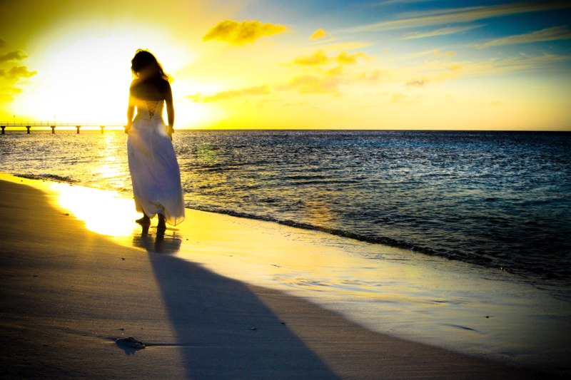 Bride walking on Bonaire beach during a beautiful sunset